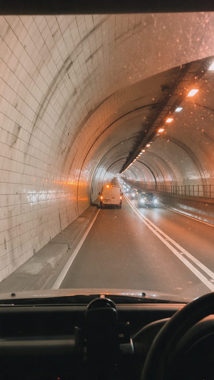An empty Thames road tunnel with a broken-down van